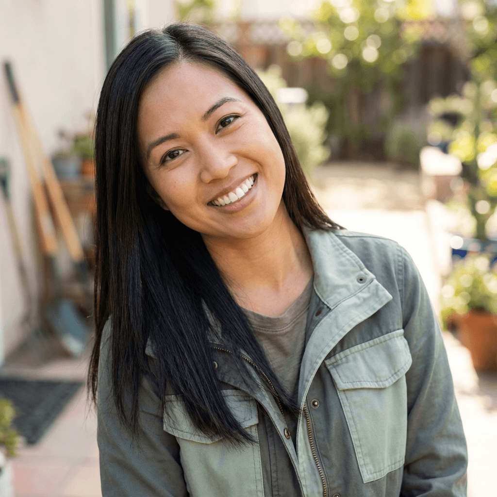 Female therapist in her early 30s, East Asian, warm and approachable, sitting in a modern therapy office
